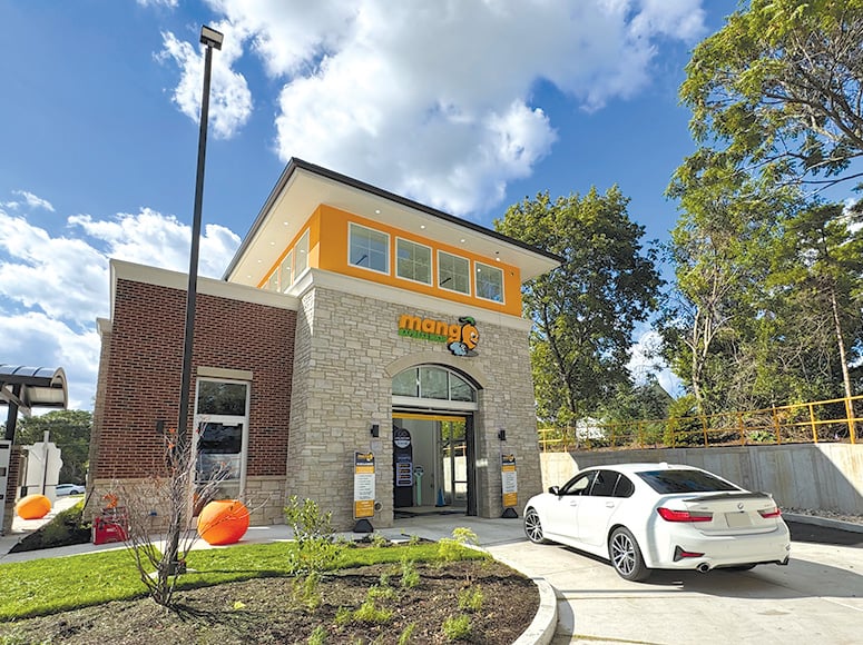 A car pulling up to the car wash entry
